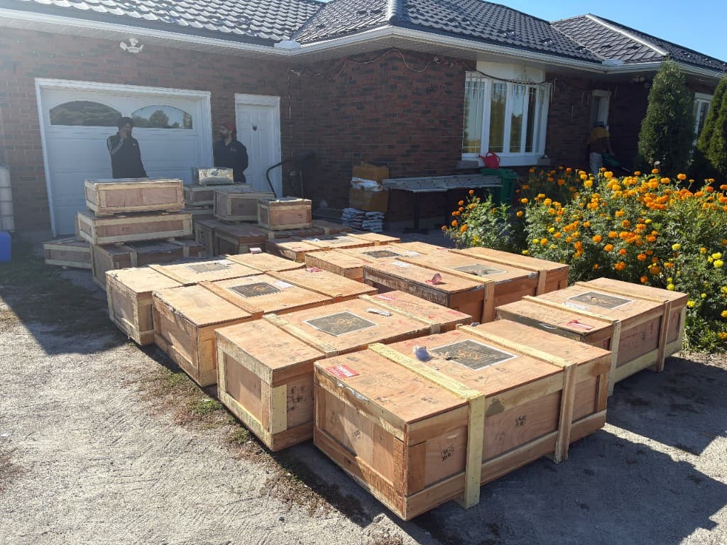 Crates holding 22 murtis from Jaipur lined up in front of Radha Sarveshwar Heritage Centre